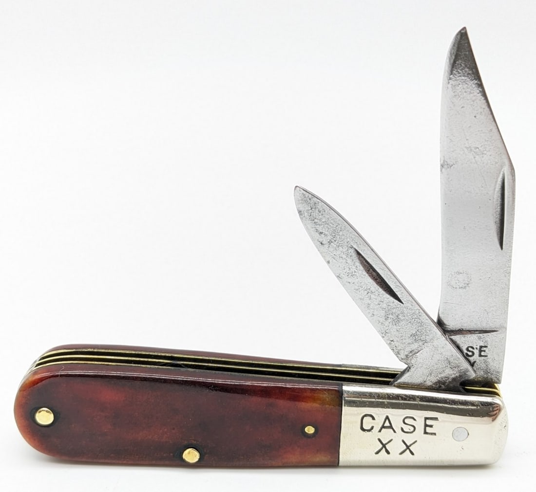 1940-64 Case XX Smooth Red Bone Barlow: Knife is in nice cleaned condition with material loss and traces of pitting on the polished blades, scattered dings on the polished bolsters, and one pin crack on the back center handle scale. Overall