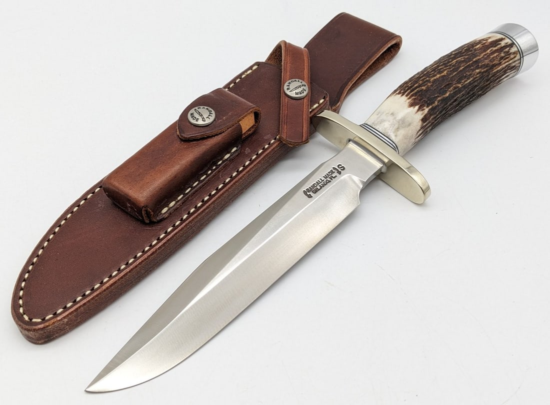 Randall Model 1C 7in Stainless All Purpose Fighter w/ Sheath: Features a stainless steel blade, nickel oblong upturned double guard, stag handle, and duralumin butt cap. Knife is in very nice condition with minimal wear from handling. Blade length measures 7in a