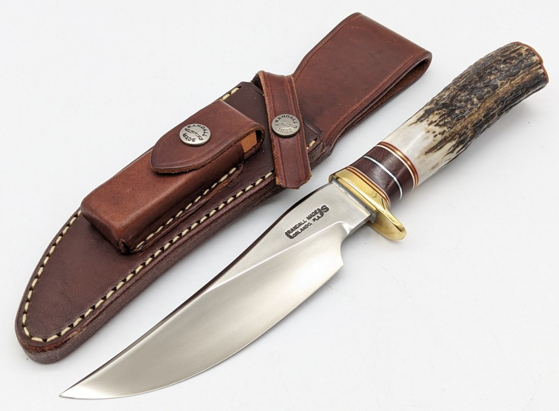 Randall Model 27 SS Trailblazer w/ Sheath: Knife features a stainless steel blade, brass downturned single guard, stag handle with brown micarta spacers, and a brass butt plate. Knife is in very nice condition with minimal wear from handling. 