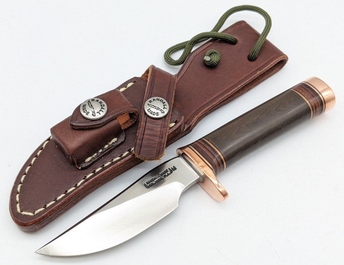 Randall Model 27M Mini Trailblazer w/ Sheath: Knife features a brass single downturned guard, brown micarta handle with leather spacers, and brass butt cap. Knife is in very nice condition with minimal wear from handling. Blade length measures 3-