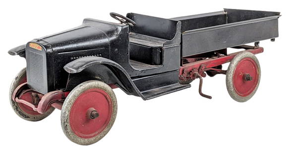 Partially Restored Buddy L Dump Truck: Partially restored Buddy L chain lift dump truck. The cab and bed of the truck have been repainted and the rest appears to be original. The dump bed is in working order. The truck has wear from age /