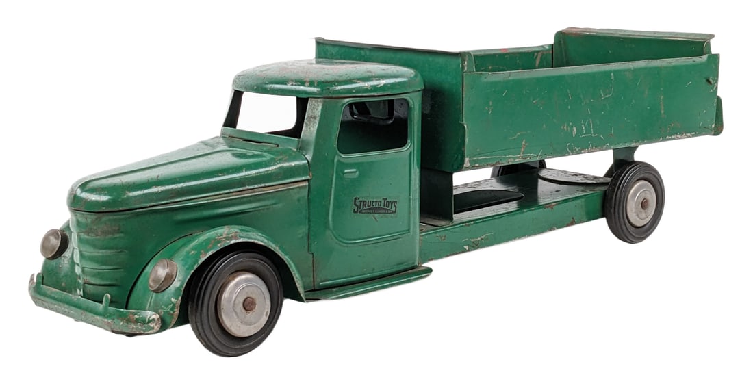 Original Structo Dump Truck: Original Structo dump truck. The truck has paint loss, scratches, and wear from play / age. Measures approximately 21" long.