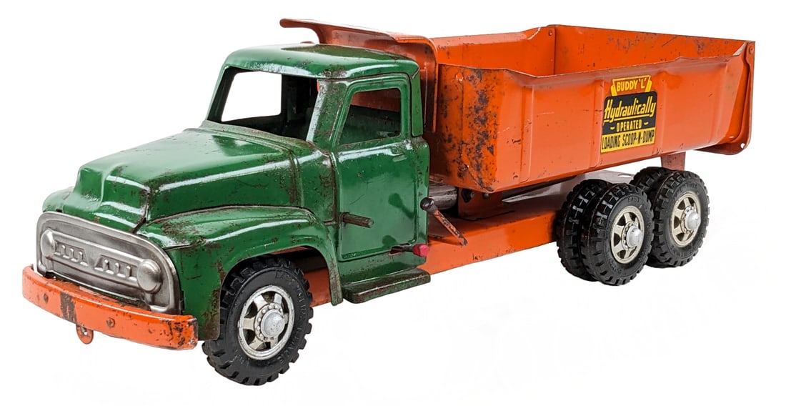 Buddy L Hydraulically Operated Dump Truck: Buddy L hydraulically operated dump truck. The truck originally had a scoop shovel on the front of the truck. The truck was oiled at sometime. It has paint loss, surface rust, and wear from play / age