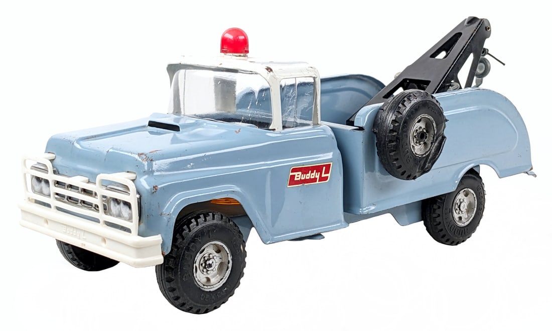 Buddy L Flat Tire Wrecker Tow Truck: Buddy L Flat Tire wrecker tow truck. The windshield was replaced and possibly the siren. The truck has original paint with some paint loss and play wear. The truck features front suspension and mounte
