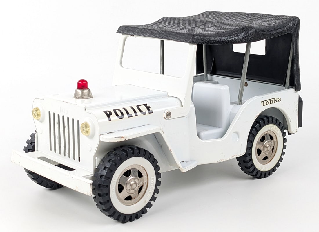 Original Tonka Police Jeep Truck: Original Tonka police Jeep truck. The truck has some minor edge wear and light play wear. One of the tabs on the plastic gas tank that connects it to the Jeep is broke off. Measures approximately 10-1