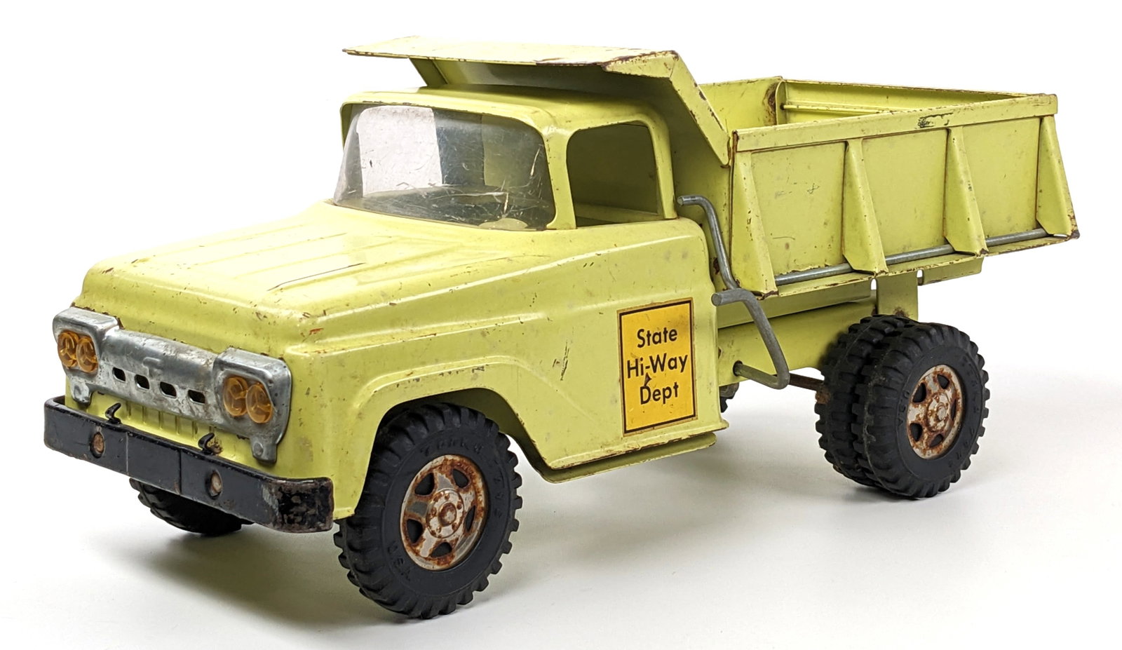 Original Tonka Lime Green State Hi-Way Dept. Dump Truck: Original Tonka Lime Green State Hi-Way Dept. dump truck. The truck has paint loss, discoloration, and surface rust to the hubcaps. Measures approximately 13-1/2" long.