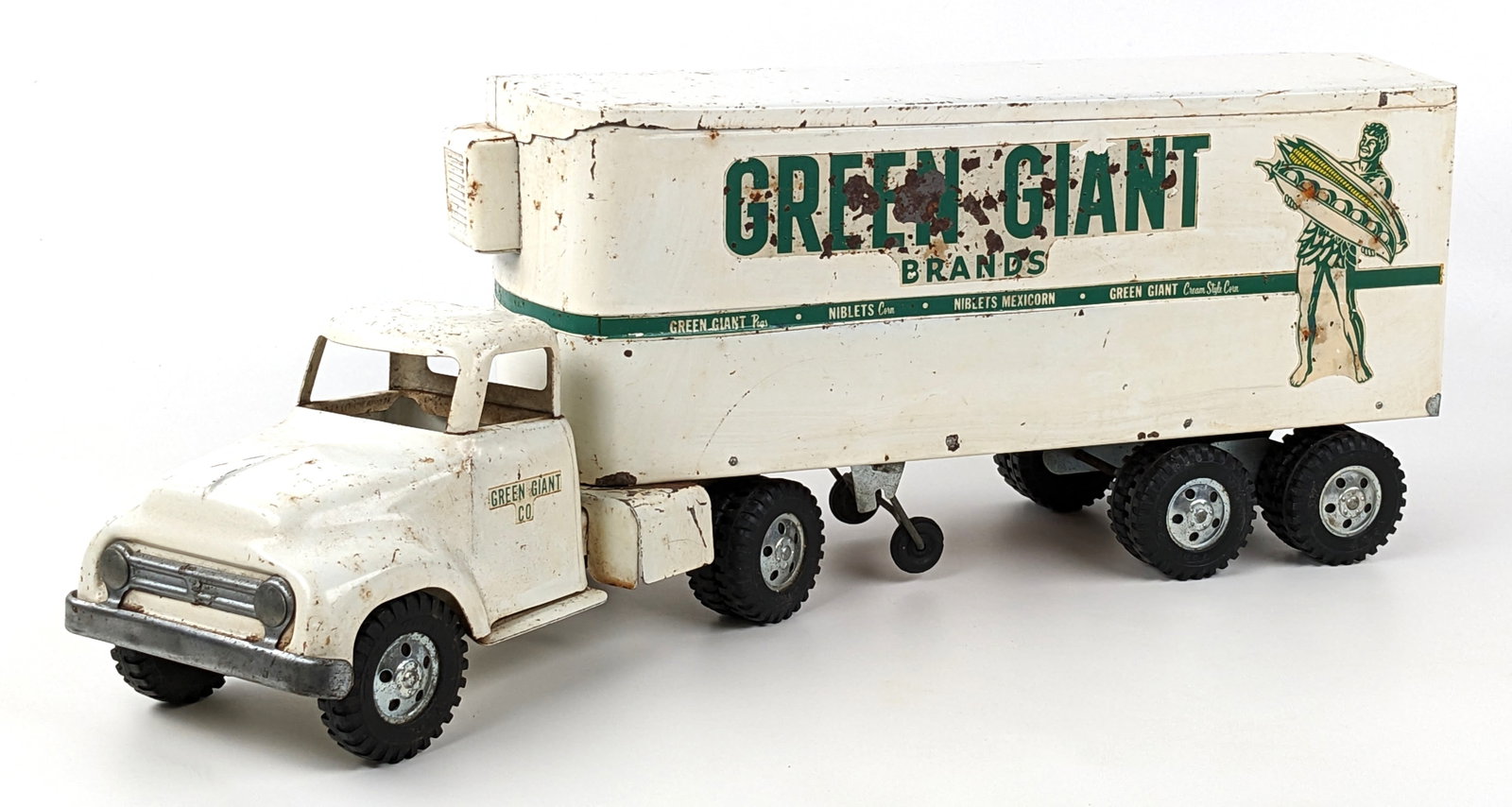 Original Tonka Green Giant Brands Truck & Trailer: Original Tonka round fender Green Giant Brands truck and trailer. The truck and trailer have paint loss, decal loss, and wear from play / age. The trailer is missing one of the door handles. Measures 