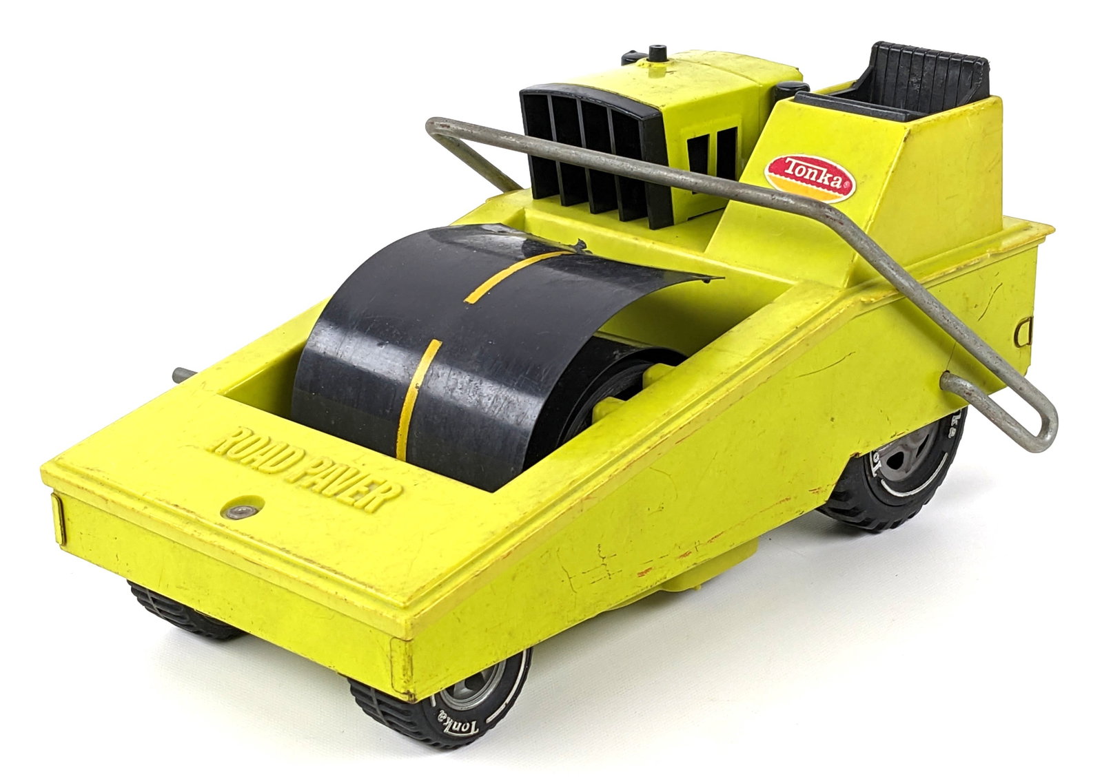 Original Tonka Road Paver: Original Tonka road paver. The paver has some scuff marks, discoloration, and play wear. It comes with the road piece. Measures approximately 10" long.