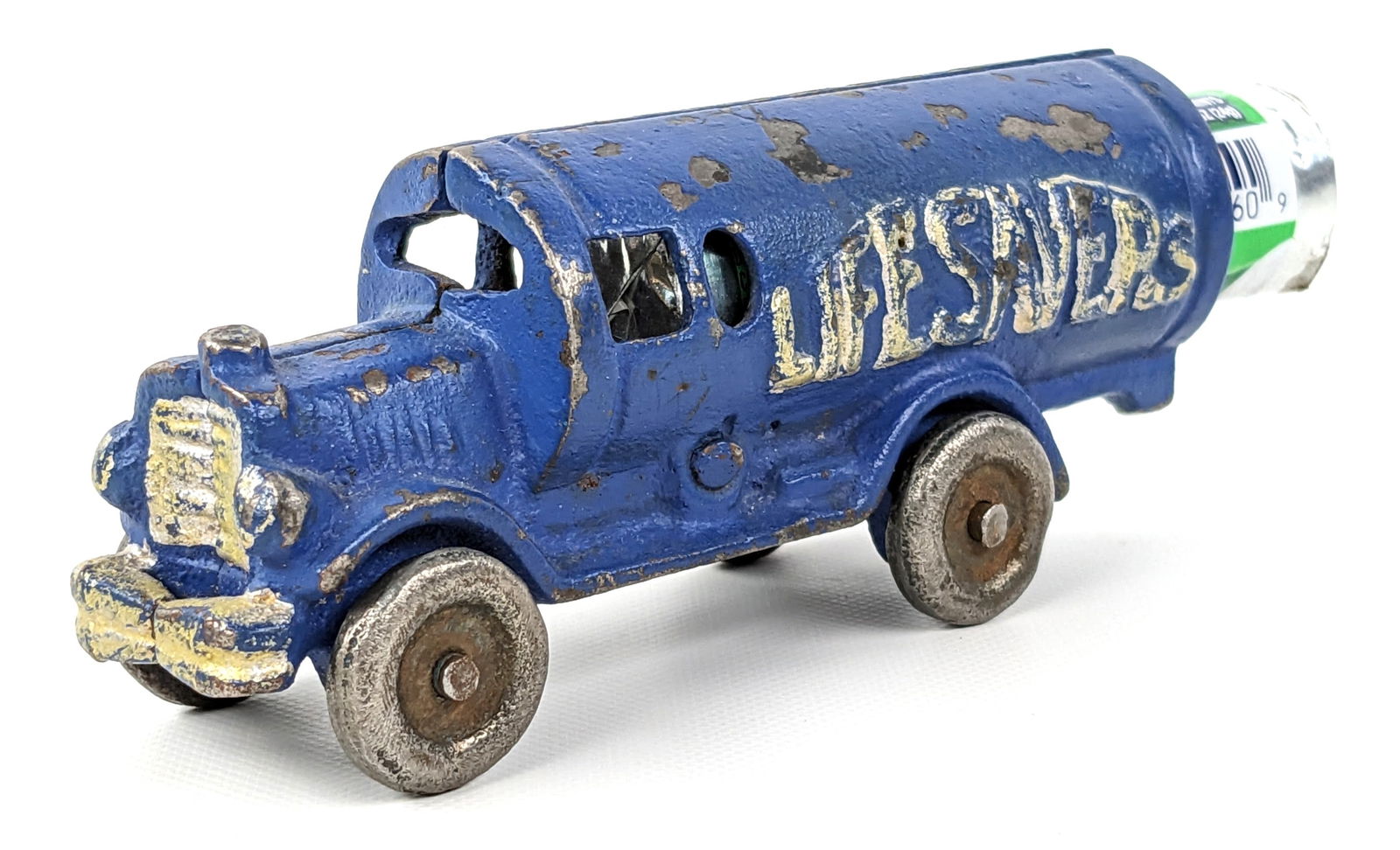Contemporary Hubley Cast Iron Lifesaver Truck: Contemporary Hubley cast iron lifesaver truck. The truck has a date of 1988 embossed on the underside. Faux paint distressing to make it look older. Measures approximately 4" long without the candy.