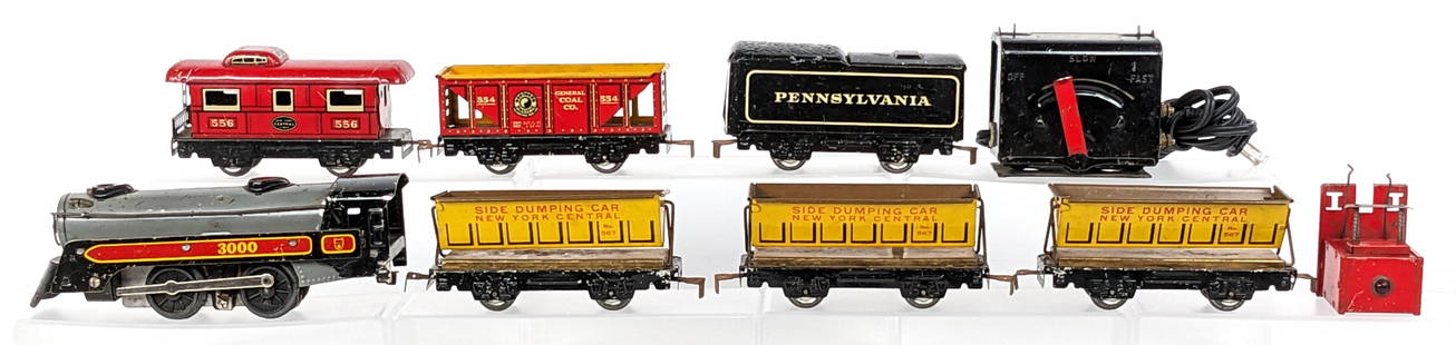 Marx Freight Train Set: Marx freight train set. The set includes engine, tender, side dump cars, hopper, caboose, and powerpack. The set shows scratches and wear from use / age.