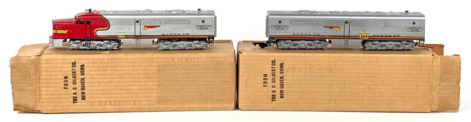 American Flyer Santa Fe 360 & 364 Diesel Locomotive Set: American Flyer Santa Fe 360 & 364 diesel loco set. Both units showing some decal loss and wear from use and age. Comes with nice original boxes. No liner for boxes.
