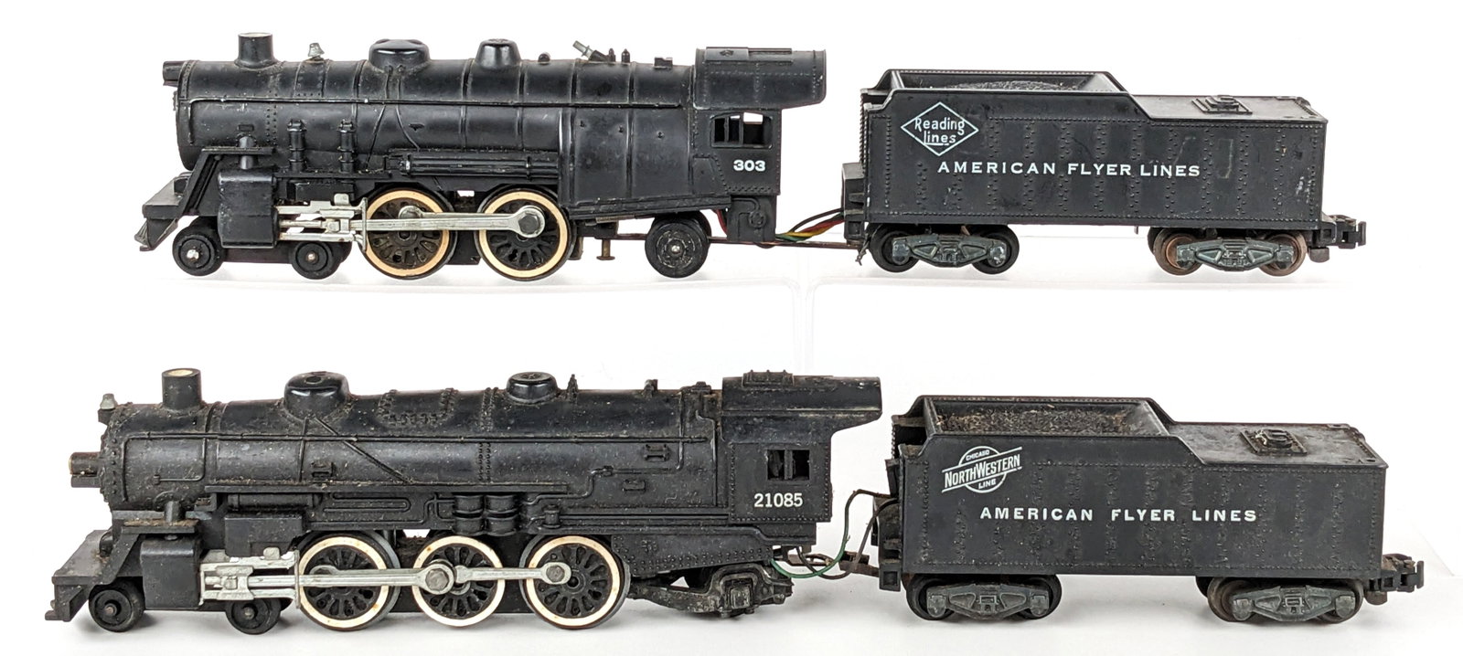 American Flyer 21085 & 303 Engines with Tenders: American Flyer 4-6-2 21085 engine with tender and 4-4-2 303 engine with tender. The 303 engine shows corrosion. Both have wear from use / age.