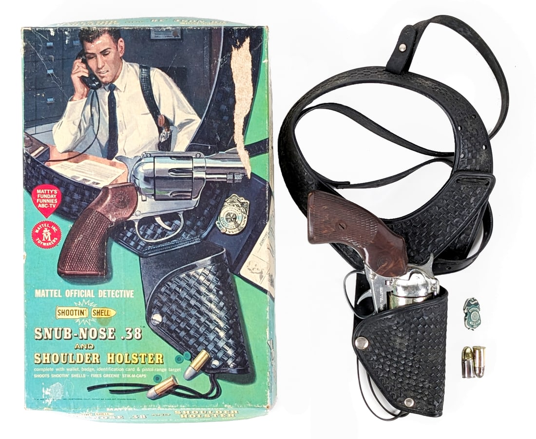 Mattel Snub-Nose .38 and Shoulder Holster in Box: Mattel Snub-Nose .38 and shoulder holster in the original box. The gun has corrosion on the hammer and the trigger sticks. There is a small chip on the plastic grip. It comes with holster, two shells,