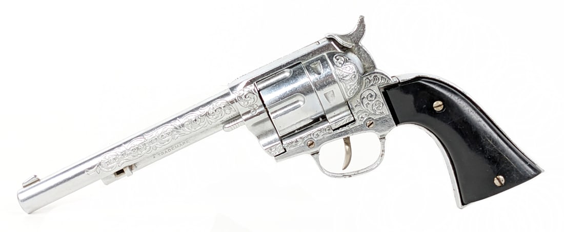 Hubley Ric-O-Shay .45 Cap Gun: Hubley Ric-O-Shay .45 cap gun revolver. The gun has some corrosion to the hammer and light wear from use and age. The gun appears to work as it should. Measures approximately 11-1/2" long.