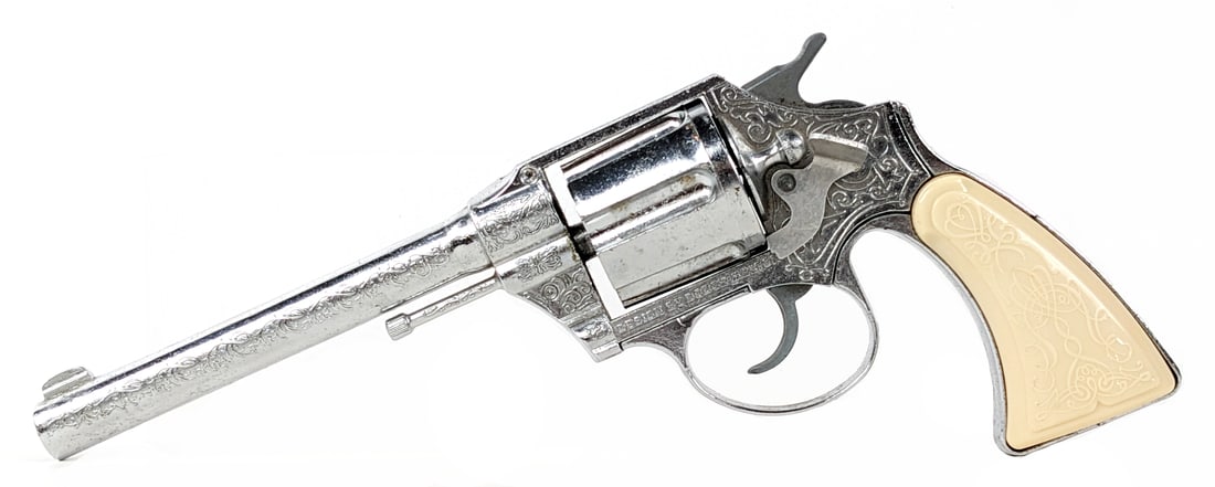 National The Plainsman Cap Gun Revolver: National Metal and Plastic Toy Co. The Plainsman realistic western toy cap gun revolver. The gun is really fancy with ornate designs. It is in excellent condition overall and functions as it should. M