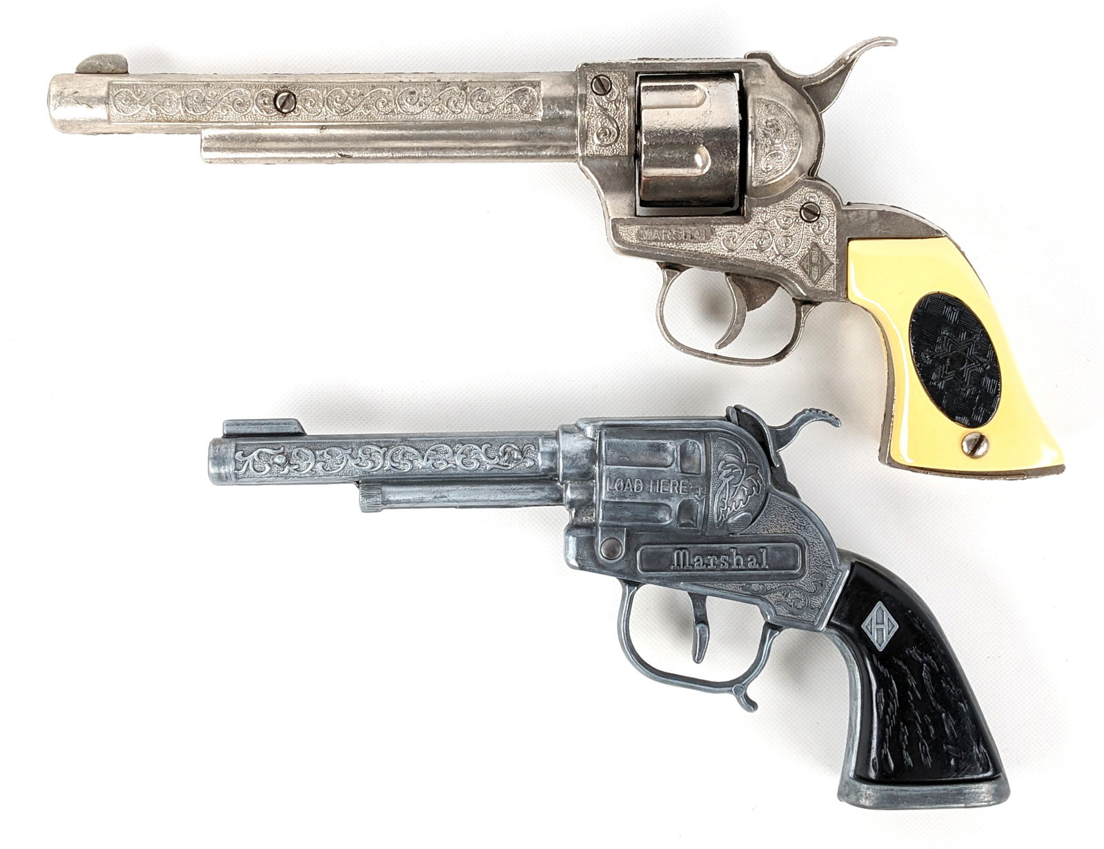 (2) Halco Marshal Cap Guns: (2) Halco Marshal cap guns. Both showing light wear from age and use. Both appear to function as they should. Largest measures 10" long.