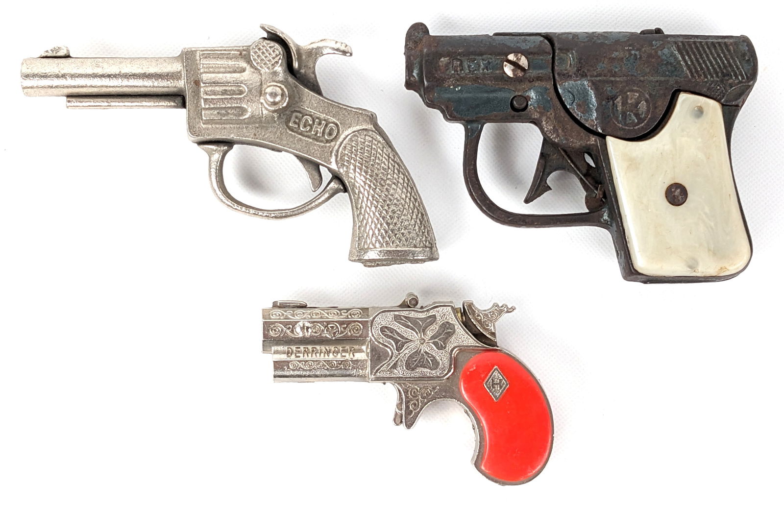Echo, Derringer, and Rex Cap Guns: Includes Stevens Echo cap gun, Leslie-Henry Derringer cap gun, and Kilgore Rex cap gun. All are in good condition with light wear from use / age. Largest measures 4-1/2" long.