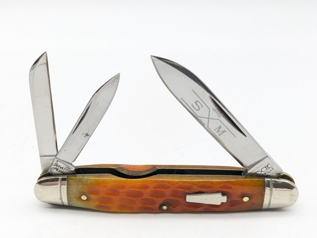 Schatt & Morgan Orange Jig Bone Whittler 043221: Knife is in nice condition with some light sharpening on the main blade, small pits on the smaller blades, and other wear from handling. Overall measures 3-1/4in when closed.