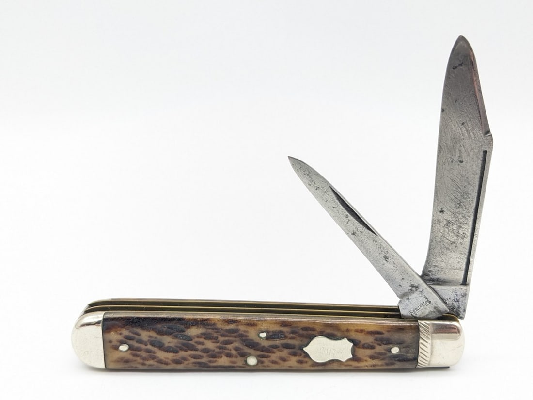 Vtg Custom Remington Jig Bone Jack Knife: Knife features custom stamped striping on the upper bolster with the name Monty hand scratched on the shield and lower back bolster. Knife is in aged condition with material loss and scratches on the