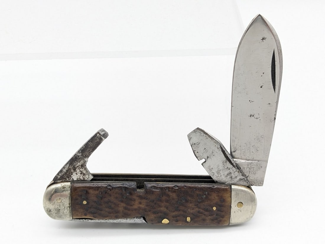Antique Wilbert Cutlery Co. Jig Bone Utility Knife: Knife is in fair aged condition with some light scratches and carbon spots on the blade, decent scratches and dings on the bolsters, and pocket worn handle scales. Overall measures 3-1/2in when closed