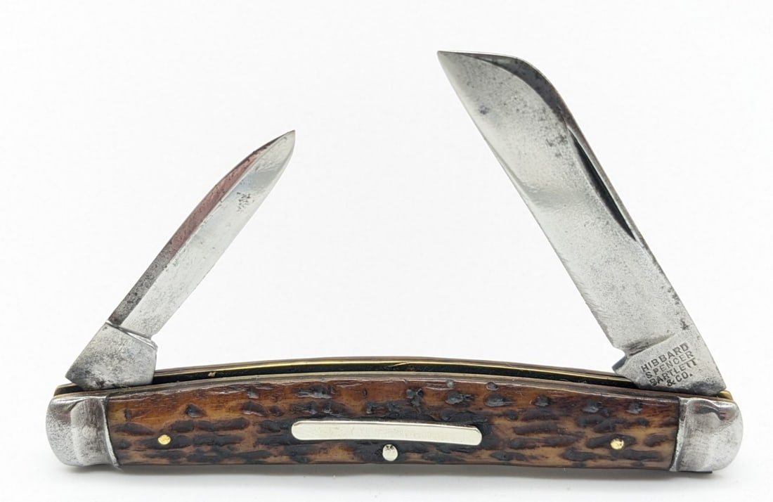 Hibbard Spencer Bartlett & Co. Jig Bone 2-Blade Congress: Knife is in nice condition with polished blades with traces of scratches and some pitting, scuffs on the bolsters, and nice handle scales. Overall measures 3-3/8in when closed.