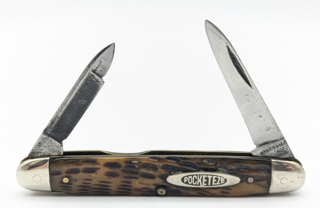 Robeson Shur-Edge Pocket Eze Jig Bone Jack Knife: Knife is in aged condition with material loss and scratches on the blades, scuffs on the bolsters, and some chips in the handle scales. Overall measures 3-1/4in when closed.