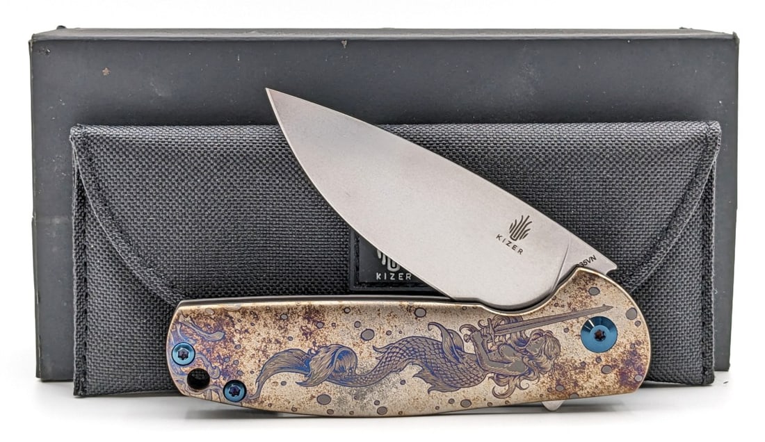 NIB Kizer Laconico Gemeni Laser Etched Flipper Folding Knife: Features laser etched and anodized titanium handle scales with the image of a mermaid with a sword. Knife is in new condition. Overall measures 4-1/8in when closed.
