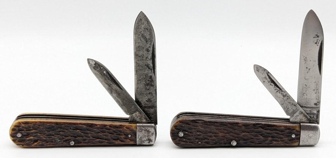 (2) Antique Voos Jigged Bone Jack Knives: Knives are in aged condition with carbon spotting and scratches on the blades, and scuffs dings and tarnishing on the bolsters. Overall measures 3-1/2in when closed.