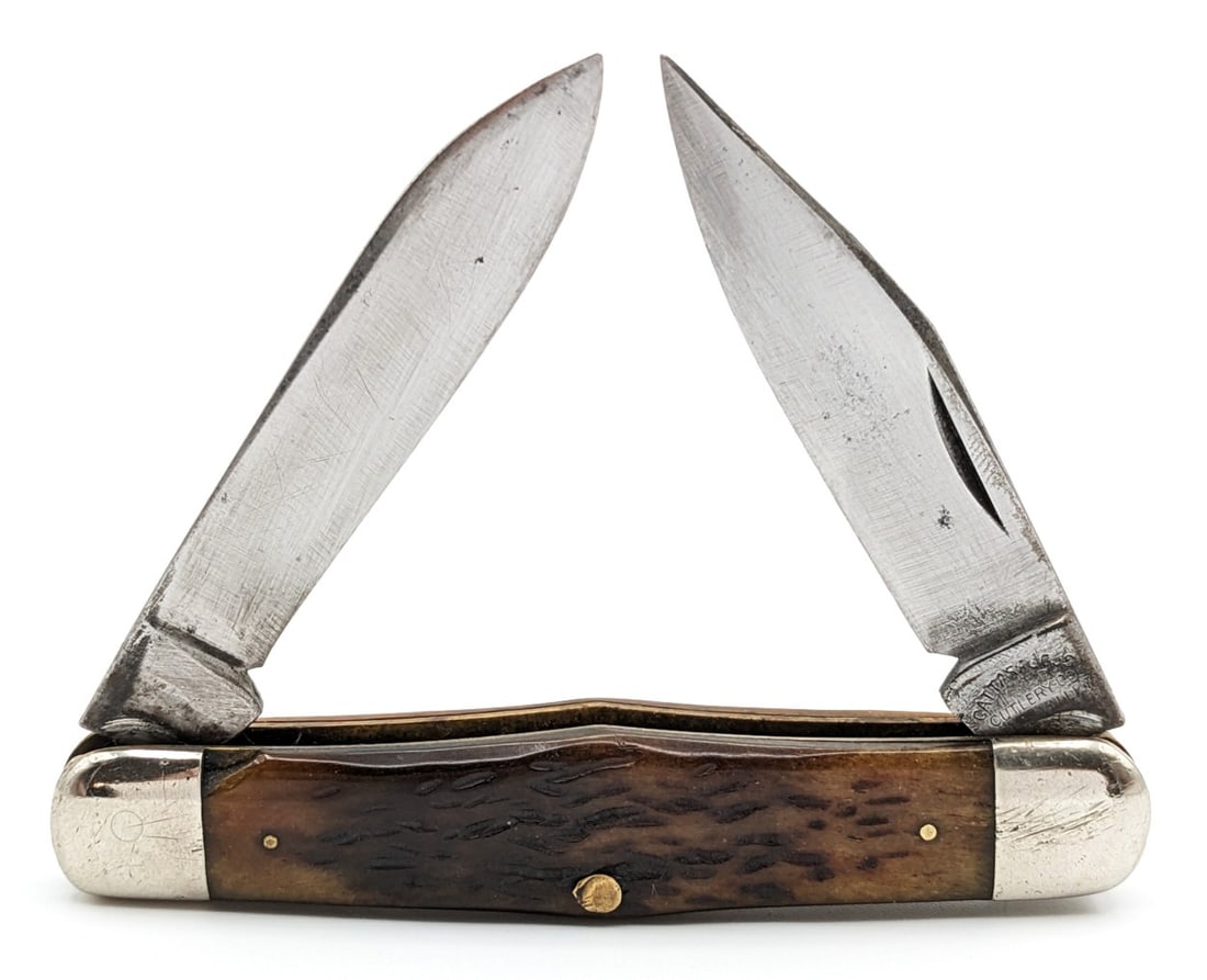 Antique Cattaraugus Cutlery Co. Jigged Bone Humpback Whittler: Knife is in fair aged condition with scratches and carbon spots on the blades, and scuffs and dings on the bolsters. Overall measures 3-3/8in when closed.