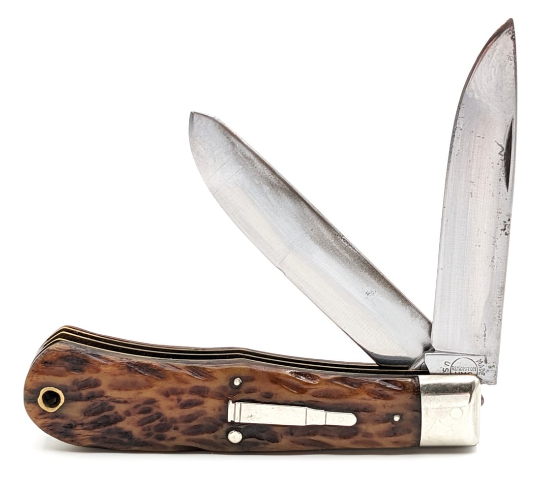 Antique Remington Jigged Bone Jumbo Bullet Trapper: Knife is in fair cleaned condition with pitting and scratches on the polished blades, light scuffs and dings on the bolsters and shield, a pin crack on both handle scales at the lanyard hole, and pitt