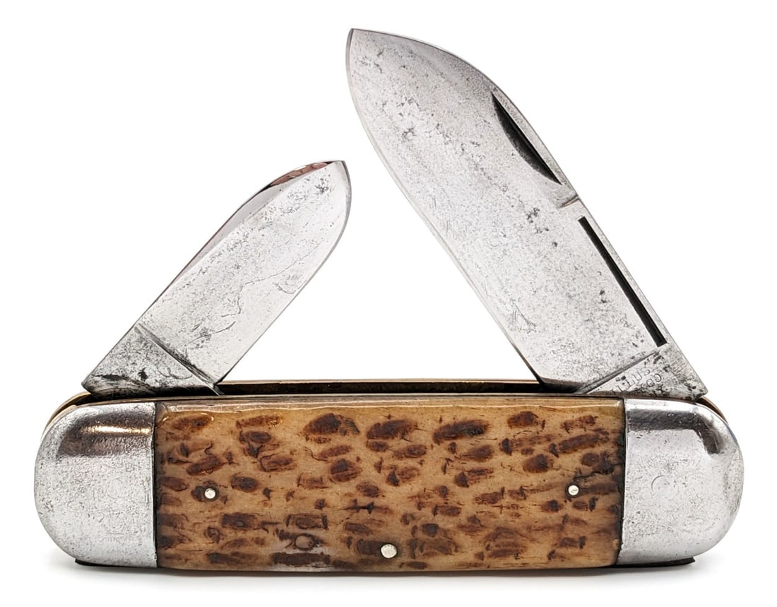 Camillus Cutlery Co. Jigged Bone Elephants Toe Sunfish Knife: Knife is in good cleaned condition with light material loss and scratches on the cleaned blades, scuffs and dings on the polished bolsters, and some large cracks on the back handle scales. Overall mea