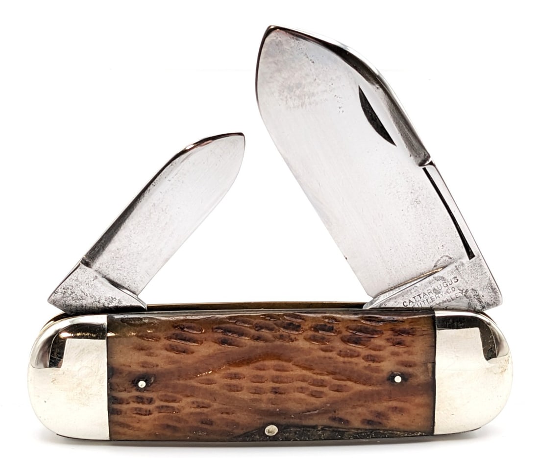 Cattaraugus Cutlery Co. Jigged Bone Elephants Toe Sunfish Knife: Knife is in nice cleaned condition with traces of pitting and scratches on the polished blades, light scuffs on the polished bolsters, a repaired large chip on the front handle scale, and pin cracks o