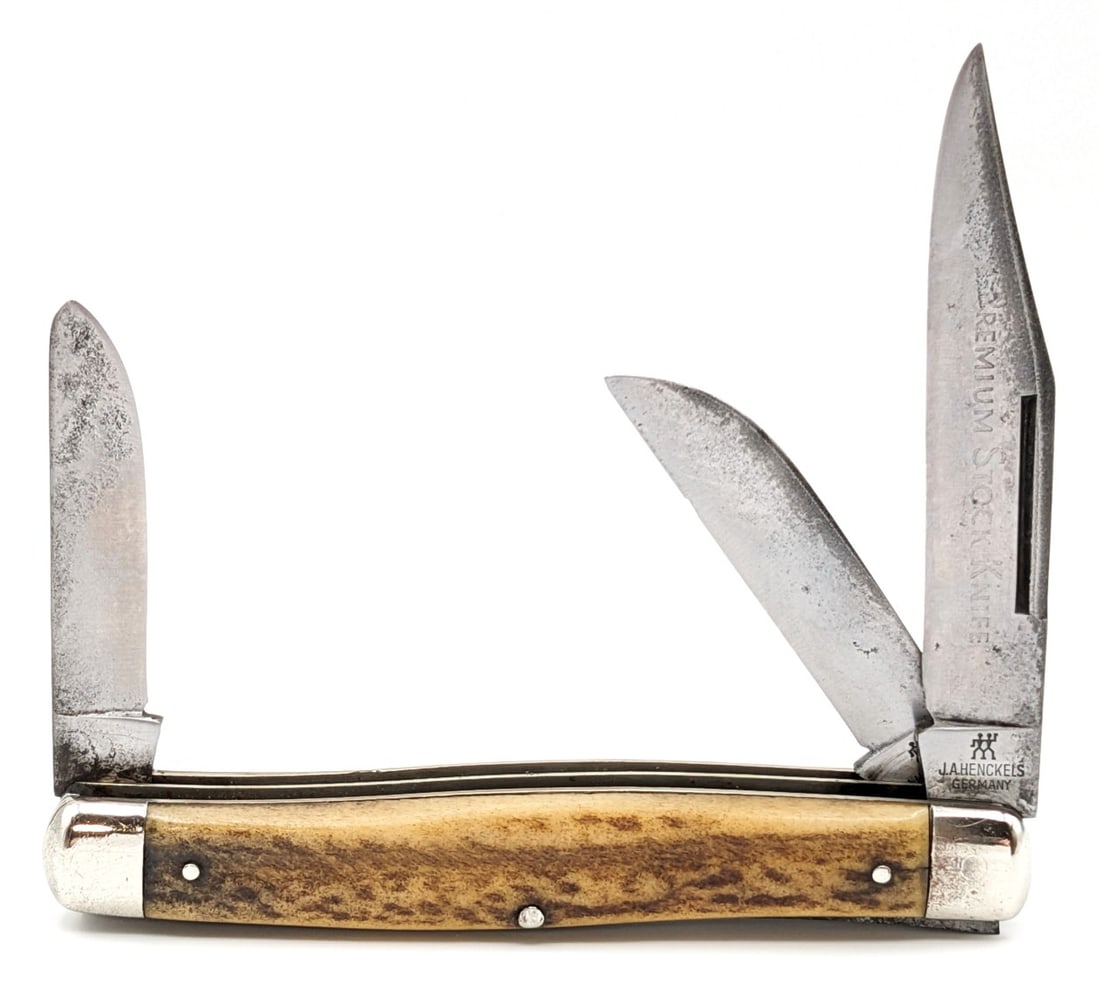 J.A. Henckels Stag Premium Stock Knife 190: Knife is in fair used condition with material loss and scratches on the blades, scuffs and dings on the bolsters, and nice handle scales. Overall measures 4-1/8in when closed.