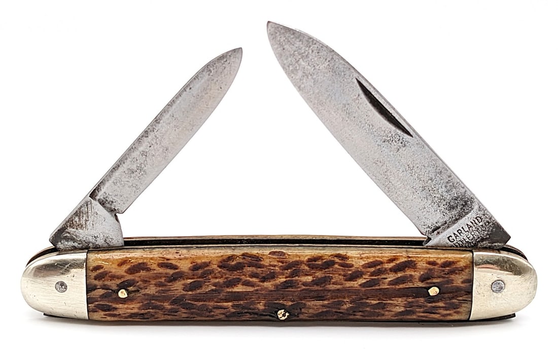 Garland Cutlery Co. Jigged Bone Cigar Knife: Knife is in good aged condition with pitting and scratches on the blades, scuffs and dings on the bolsters, and nice handle scales. Overall measures 3-3/4in when closed.