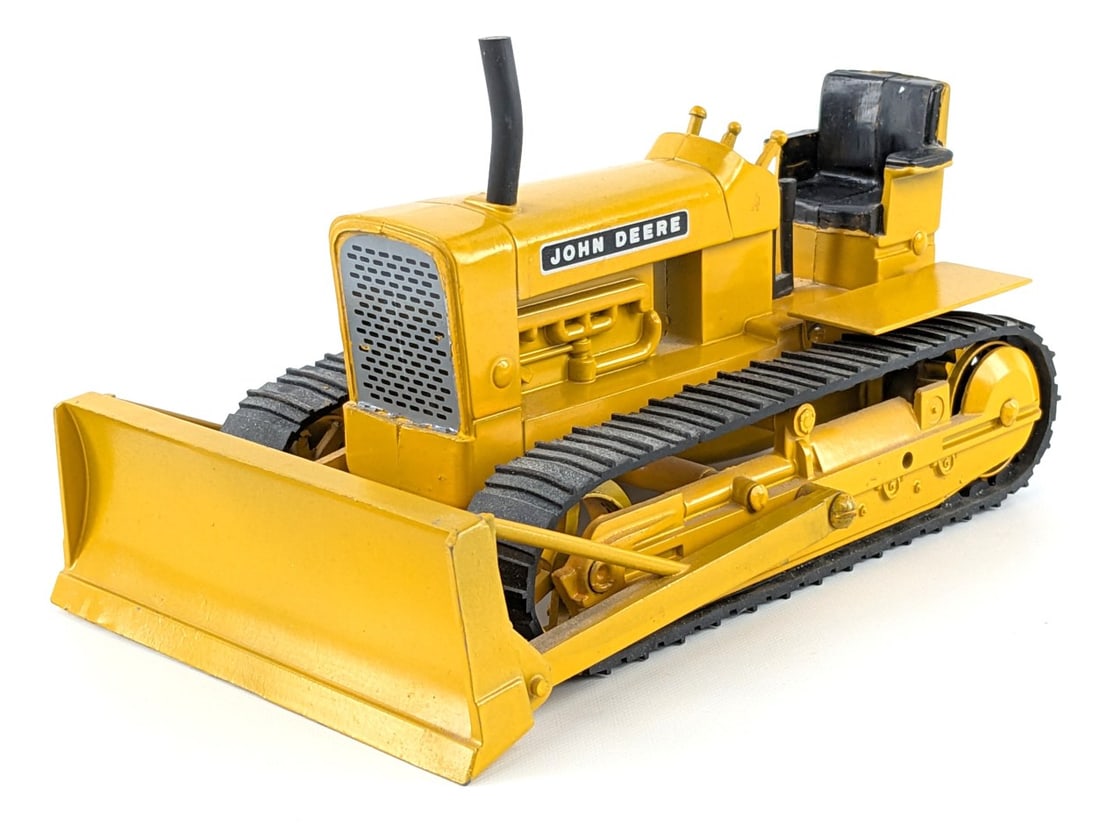 1/16 Ertl John Deere 1010 Crawler with Blade: 1/16 Ertl John Deere 1010 crawler with blade. The crawler has some dust and tiny paint chips, but overall good condition. Appears to be a nice older restoration.
