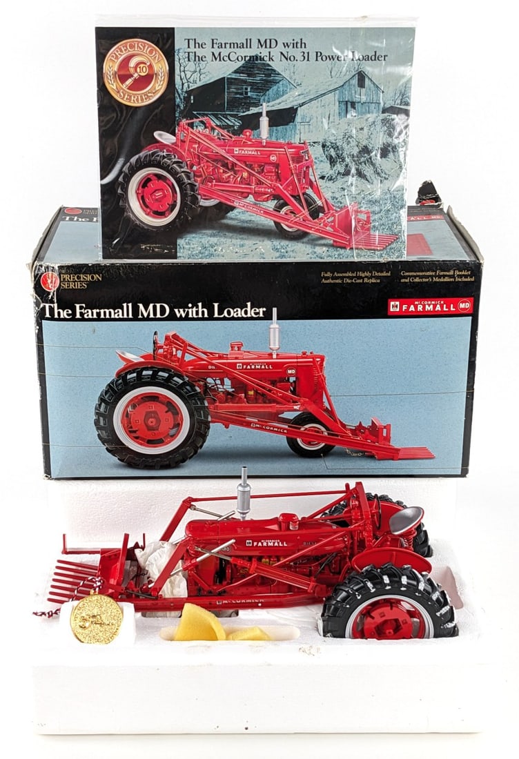 1/16 Ertl Farmall MD Tractor with Loader Precision Series #10: 1/16 Ertl Farmall MD narrow front tractor with loader. Precision Classics Series #10. The tractor has light dust from display. It comes with the booklet and medallion. The box has some wear and tear.