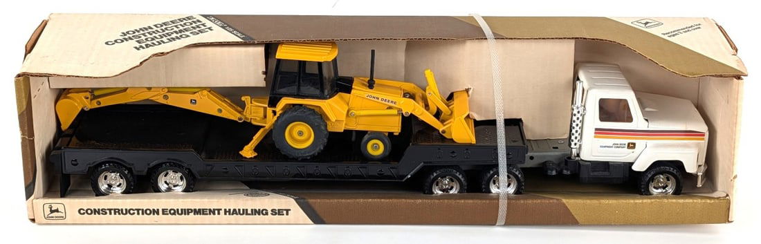 1/25 Ertl John Deere Construction Equipment Hauling Set: 1/25 Ertl John Deere construction equipment hauling set. The set includes semi tractor, lowboy and backhoe. Good condition new in the box.
