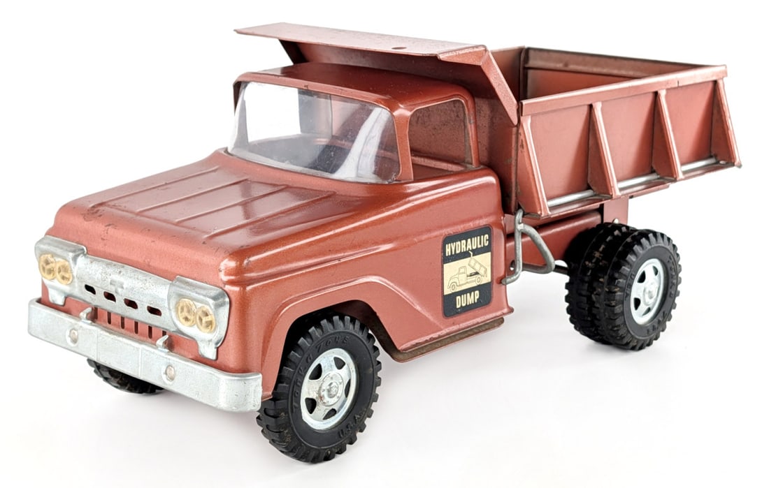 Original Tonka Hydraulic Dump Truck: Original Tonka hydraulic dump truck. The hydraulic dump works, but dumps in a rapid motion. The truck has some light paint loss and wear from age. Measures approximately 13" long.