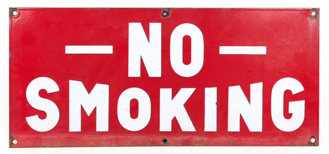 SSP "No Smoking" Sign: Vintage single sided porcelain "No Smoking" sign. The sign is missing four of the gromets, has surface rust, and wear from use and age. Measures approximately 20" across by 9" tall.