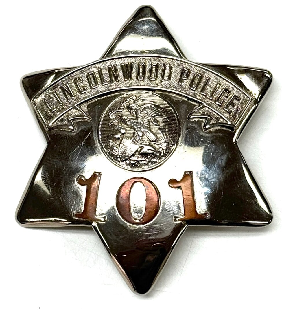 Obsolete C.H. Hanson Lincolnwood Illinois Police Pie Plate Badge #101: Obsolete Lincolnwood Illinois Police Pie Plate Badge #101 with copper numbers. Badge is in nice condition with a pin back, has some light age and use wear. Back is maker marked C.H. Hanson Chicago. Ba