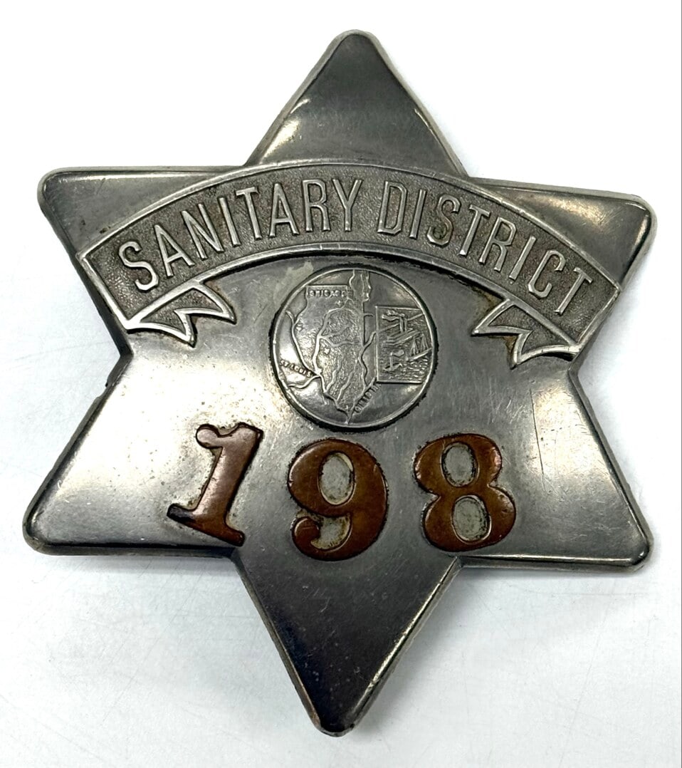 Obsolete Chicago Sanitary District Pie Plate Badge #198: Obsolete Chicago Sanitary District Pie Plate Badge #198 with copper numbers. Badge is in nice condition with a pin back, has some light age and use wear. No maker mark. Badge measures approximately 3-