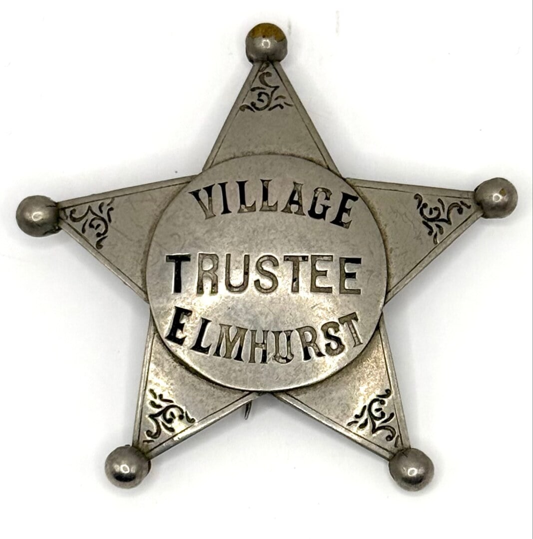 Obsolete Childs Elmhurst Illinois Village Trustee Star Badge: Obsolete Elmhurst Illinois Village Trustee 5-Point Star Badge with ball tips. The badge is in good condition with a pin back, has age and use wear. Maker marked Childs Chicago. Badge measures approxim