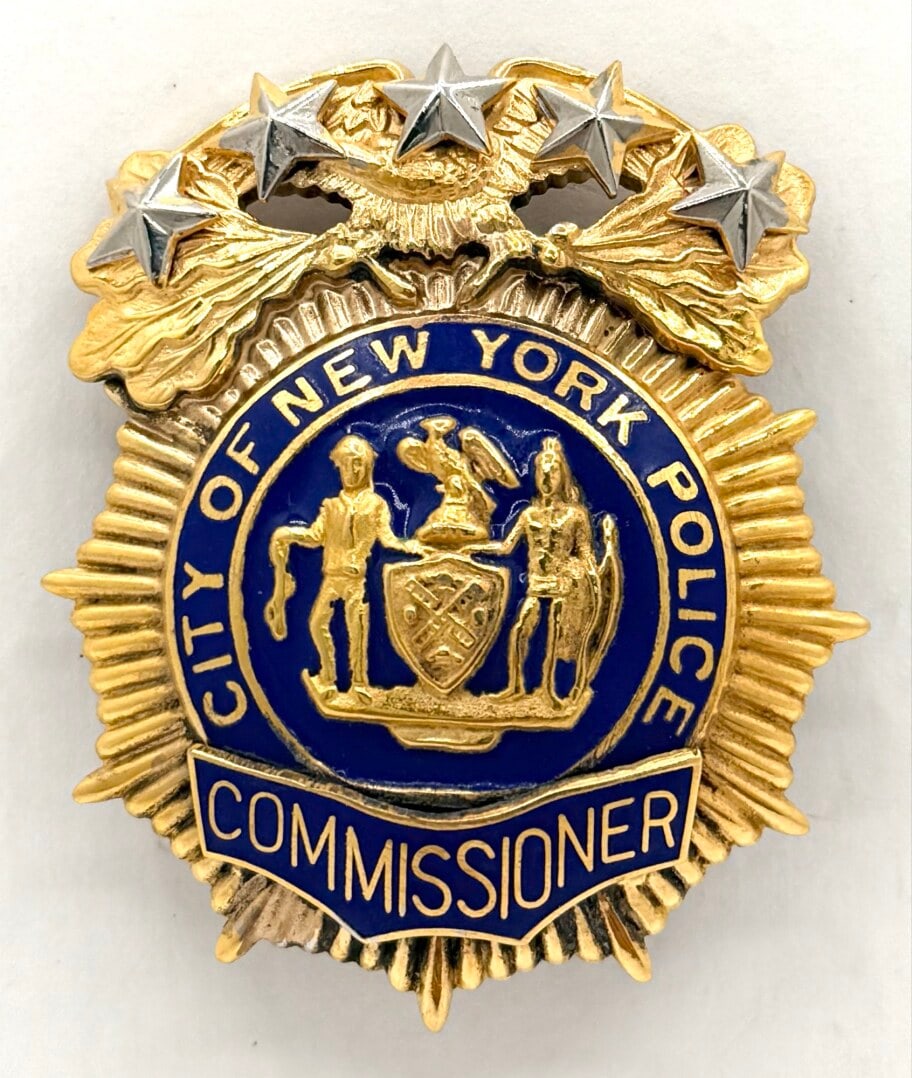 Obsolete City Of New York Police Commissioner Badge: Obsolete City Of New York Police Commissioner Badge. The gold-tone badge has pin lugs on the back with some light age and use wear. No maker mark. Badge measures approximately 2-5/8" tall x 2-1/4" acr