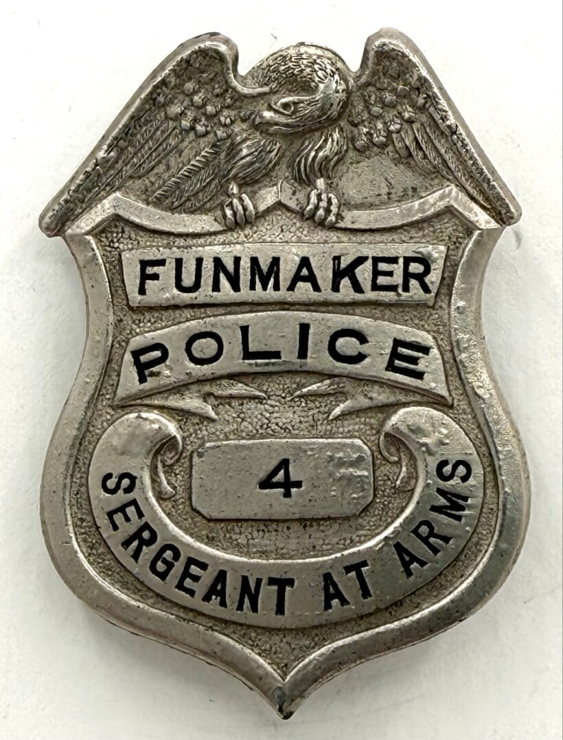 Obsolete Funmaker Police Sergeant At Arms Shield Badge #4: Obsolete Funmaker Police Sergeant At Arms Shield Badge. The badge has a pin back with some age and use wear. No maker mark. Badge measures approximately 2-1/2" tall x 1-3/4" across.