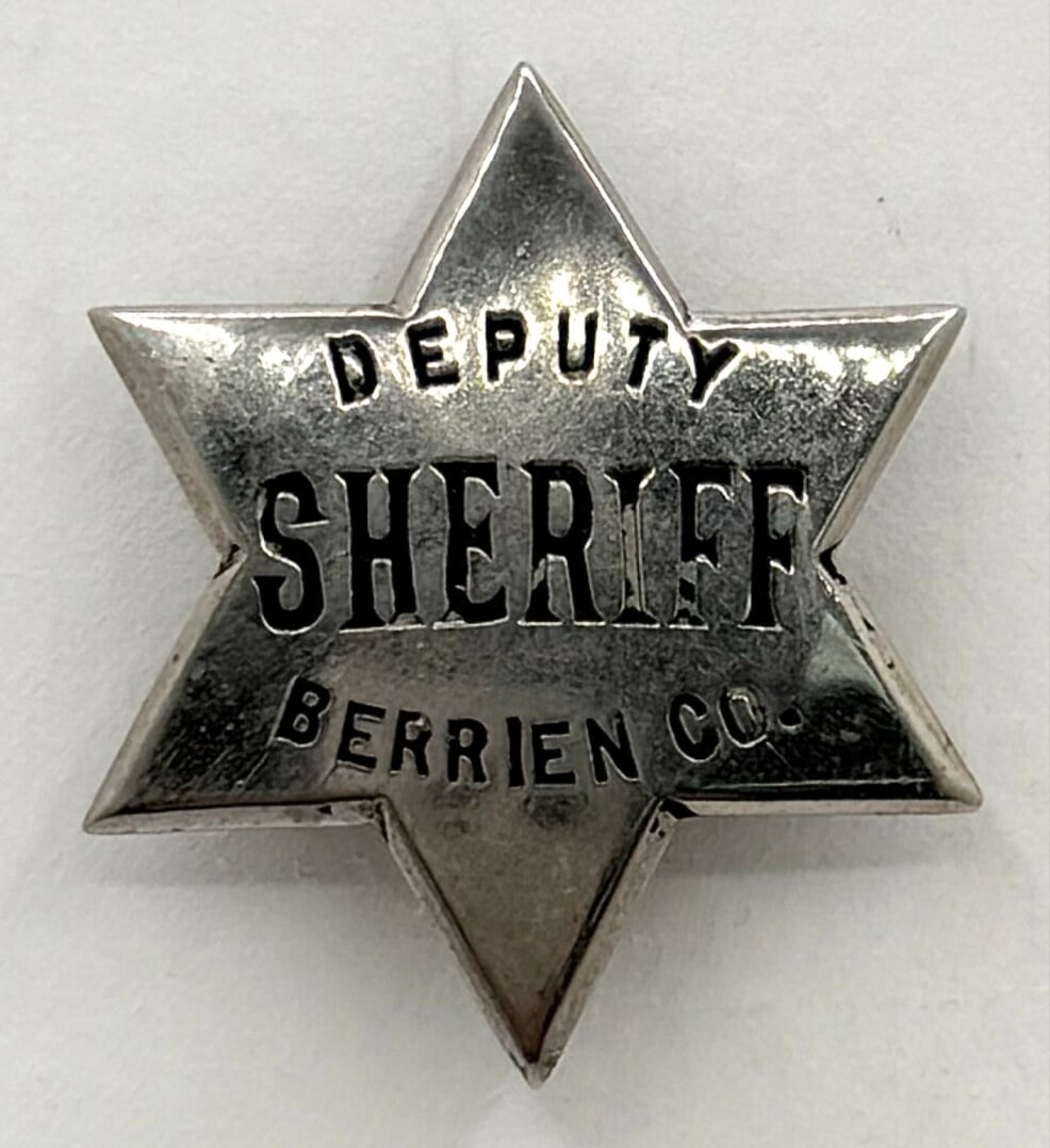 Obsolete Berrien County Michigan Deputy Sheriff Star Badge: Obsolete Berrien County Michigan Deputy Sheriff 6-Point Star Badge. The badge has a pin back and shows some age and use wear. No maker mark. Badge measures approximately 2-1/8" tall by 1-7/8" across.