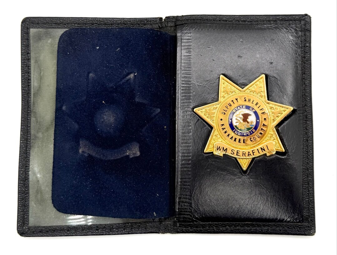 Obsolete Named Kankakee County Illinois Deputy Sheriff 7-Point Star Wallet Badge: Obsolete Named Kankakee County Illinois Deputy Sheriff 7-Point Star Badge in leather wallet. The gold-tone badge has a slide back and shows some light age and use wear. No maker mark. Badge measures a