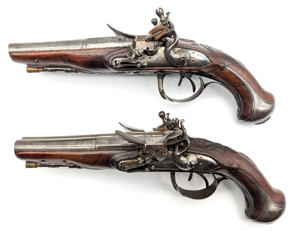 Pair of Fine Spanish .48 Cal Double Barrel Flintlock Pistols: Manufacturer: Juan Santos, Model: Double Barrel Flintlock, Type: Black Powder, Caliber/Gauge: .48 Cal, Barrel: 5 inch, Choke: , Finish: Gray Patina, Grip: Quality Rosewood, Stock: , Condition: Nice wi