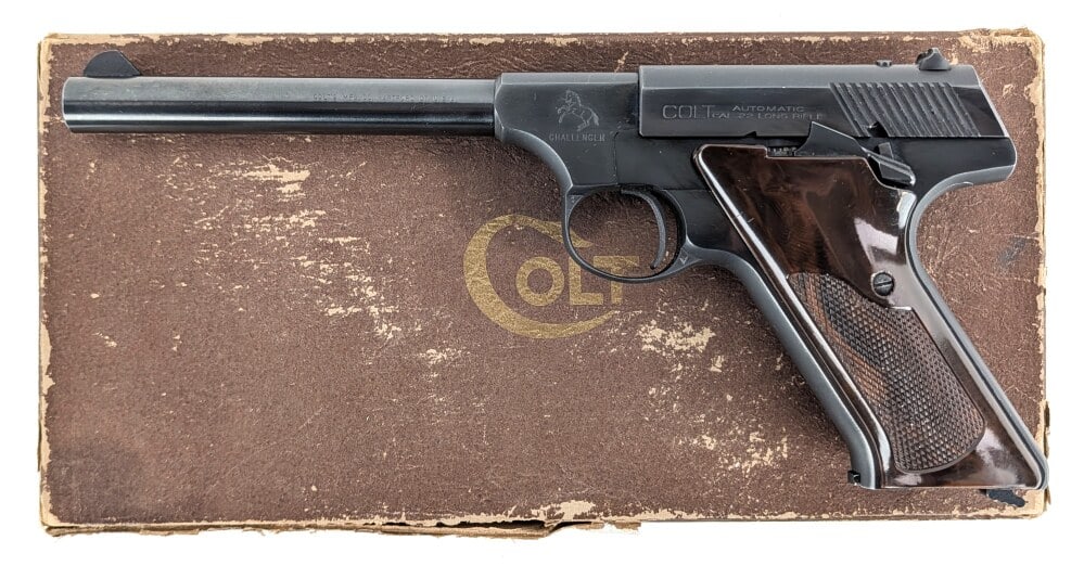 1951 Colt Challenger .22 LR Semi Auto Pistol w/ Box: Manufacturer: Colt, Model: Challenger, Type: Pistol, Caliber/Gauge: .22 LR, Barrel: 6-1/8 inch, Choke: , Finish: Blued, Grip: Checkered Marbled Brown Plastic, Stock: , Condition: Very nice with light