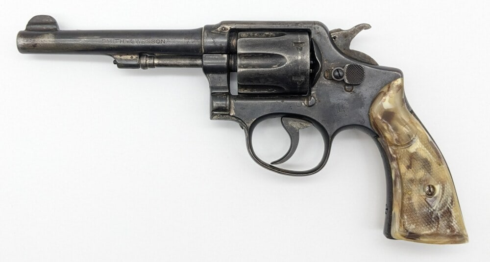 Smith & Wesson Model 10 .38 S&W Spl Revolver: Manufacturer: Smith & Wesson, Model: 10, Type: Revolver, Caliber/Gauge: .38 S&W Special, Barrel: 5 inch, Choke: , Finish: Blued, Grip: Marbled Plastic, Stock: , Condition: Aged with finish wear, light