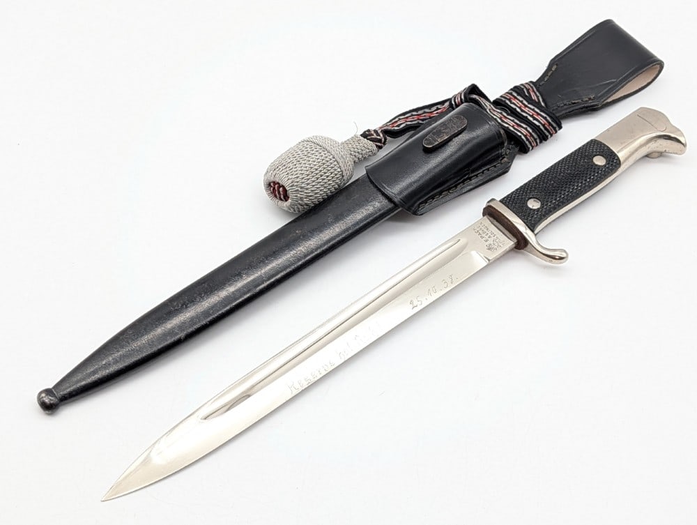 WWII German E. Pack & Sohne Hand Engraved Dress Bayonet w/ Scabbard Frog & Acorn: Features a nickel plated blade with hand engraving with the phrase and date "Reserve hat Ruh! 25.10.38" and on the reverse with their name and unit "Gefr. Rammereif Goslar 10(Jager) J.R. 17", nickel p
